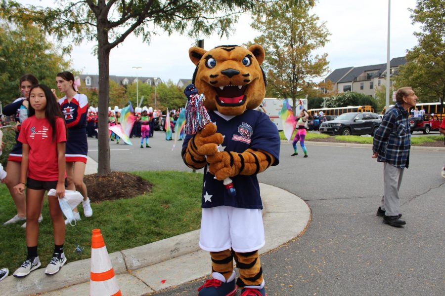 TJ the tiger poses with the spirit stick before the parade begins.