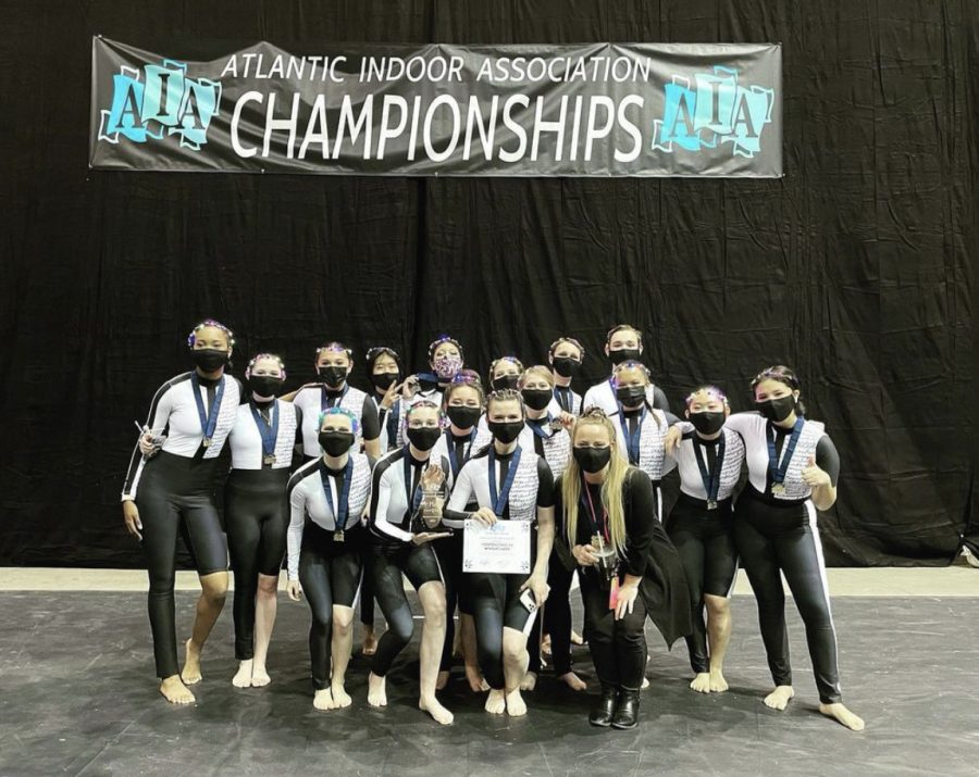 The Independence Winterguard poses after winning first place in their class at the AIA Championship in Hampton, Virginia. (Kelly Barclay holds the certificate at center and to the right of her is Mrs. Talitha Harrington).