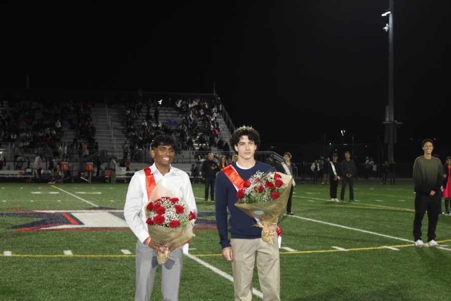 Seniors Naren Kanugula and Xavier White pose on the football field after being named homecoming royalty at halftime of the Homecoming football game. Photo courtesy of Suhani Dixit, 10.